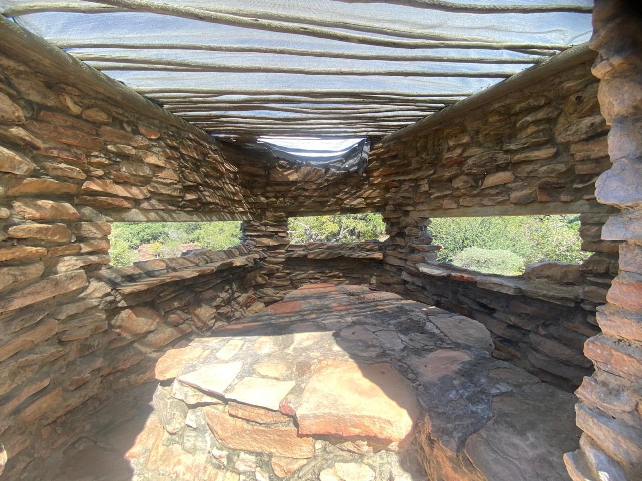 Open stone shelter with views through the walls